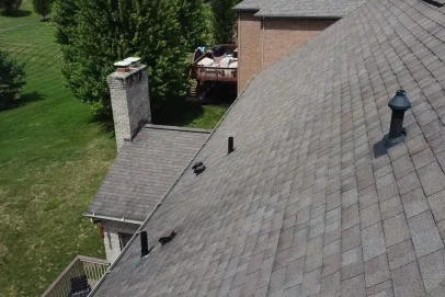Rooftop view with chimney and ventilation pipes.