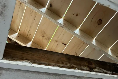 Ceiling with exposed wooden beams and boards.
