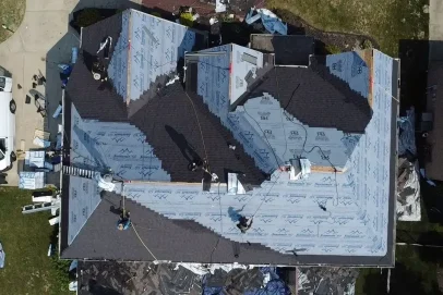 Roof installation with workers from above.